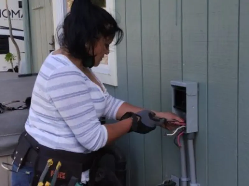 Licensed electrician wiring an exterior subpanel in McNair